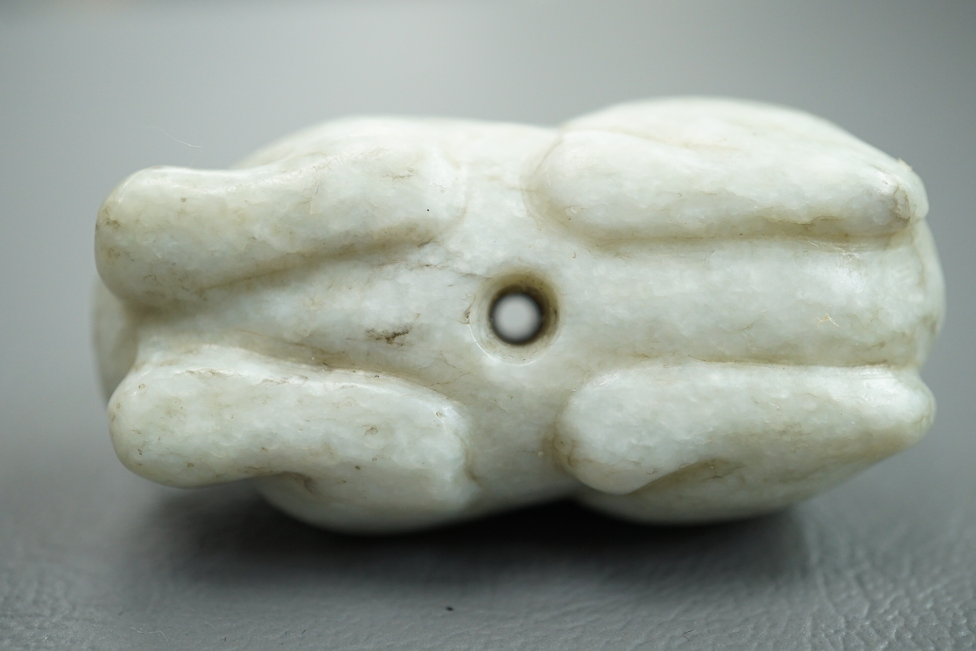 A Chinese white and black jade figure of a recumbent tiger, Song dynasty